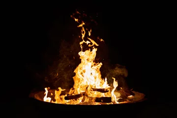 Fototapeten Feuer & Flamme wood fire in a big cement bowl at the beach  © Francisco Zeledon