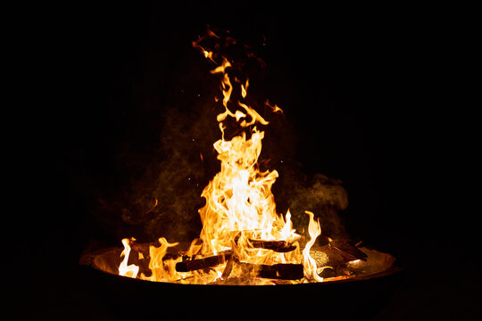 wood fire in a big cement bowl at the beach