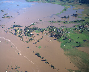 flood waters from the Hawkesbury river surround farm houses and crops near Windsor , Sydney Australia in 1986..