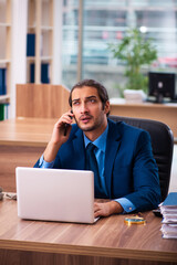 Young male employee working in the office