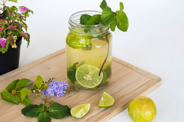 herbal healthy drinks lemon, peppermint cold for health care with flowers arrangement flat lay style on background white