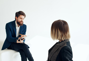 Business man and woman in suit on a light background recruiting vacancies resume