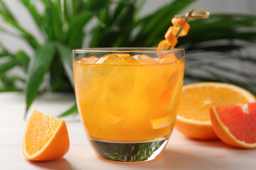 Delicious orange soda water on white table