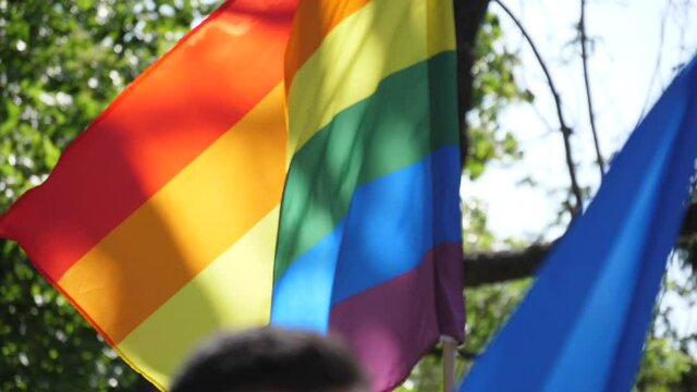 holding rainbow flag in lgbt parade