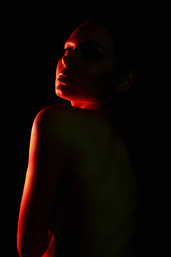 Red Female silhouette, beautiful woman in color lights