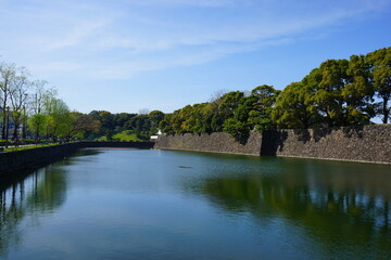 Fototapeta na wymiar Tokyo, Japan - March 2021: Imperial palace moat (Sotobori) and stone wall (fortress) in Tokyo, Japan - 皇居 外濠