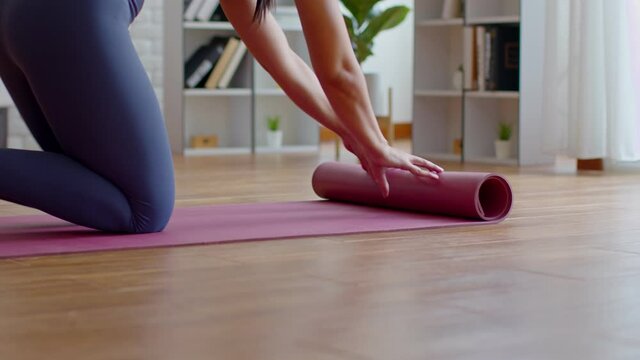 Close up Hands preparing Yoga mat on the floor ready for practice and relax with yoga indoor at home,Wellness Recreation Concept