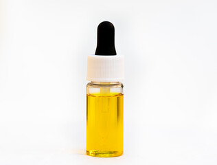 Oil in a clear bottle with oil dropper bottle isolated on a white background.
