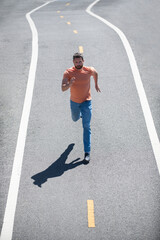 Top view runner at road. Man running on country road, sport motivation training.