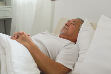 Asian Elderly man sleep and sweet dream on bed.