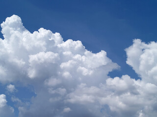 Naklejka na ściany i meble white fluffy clouds on brightly blue sky in sunny day