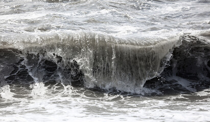 Splashing big waves on the seashore.