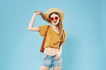 Woman tourist backpack travel fashion summer clothes dark sunglasses blue background