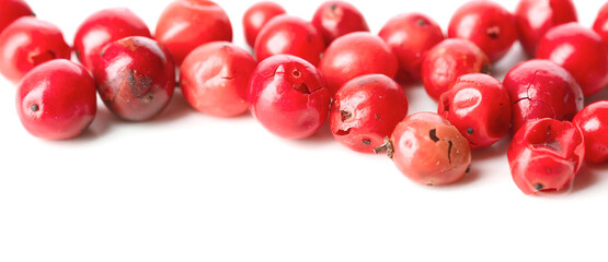 Red peppercorns on white background