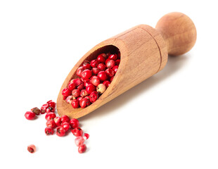 Scoop with red peppercorns on white background