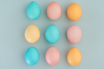 Delicate beautiful Easter background with Easter eggs painted in pastel colors. Top view, flat lay