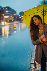 Woman with yellow umbrella outside