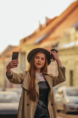 Woman taking selfie with her smartphone