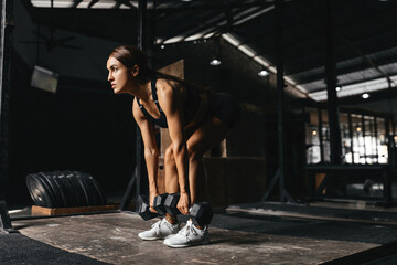 Fototapeta na wymiar Woman fitness trainer portrait on a gym background