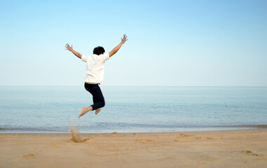 Fototapeta na wymiar flying jump man to ocean in holiday wih copy space