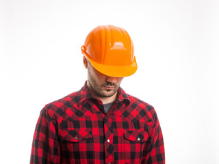 A man in a plaid shirt and a construction helmet on a white background. Concept Labor Day.