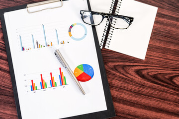 Statistical reports on wooden table.