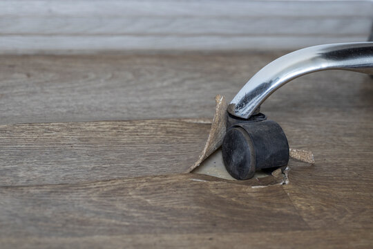 Damaged Linoleum floor covering by office chair wheels.