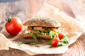 Close up of a sandwich with salmon, lettuce (arugula) and wholemeal bread