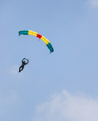 Skydiver On Colorful Parachute in blue sky