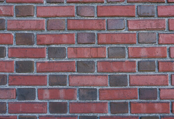 Brick wall made of red and burgundy bricks. Copying a space