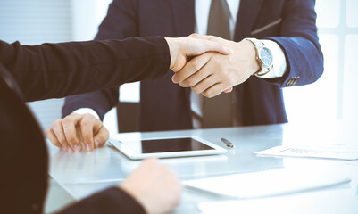 Business people or lawyers shaking hands finishing up a meeting, close-up. Negotiation and handshake concepts