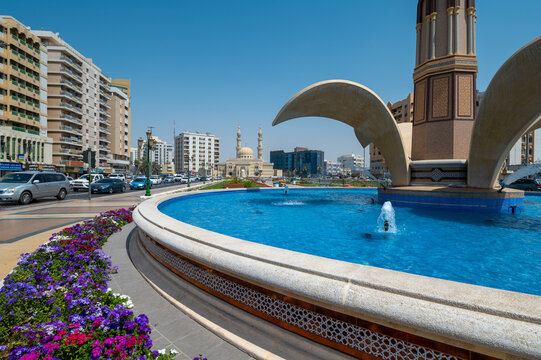Sharjah, United Arab Emirates - March 24, 2021: Zahra mosque and Clock Tower fountain in Sharjah emirate downtown in the UAE