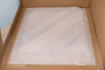 Tissue paper sheet pasted to carton box with shipping tape