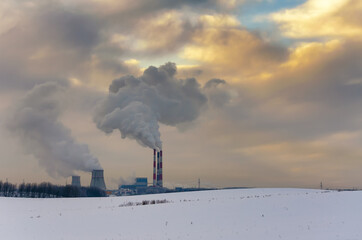 thermal power plant and cooling towers near the city in winter