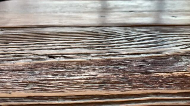 Dark brown wood with light aged annuals on the wooden shelf or table. Review of a beautiful empty old wooden tabletop. Aged rustic wooden background. 