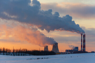 thermal power plant and cooling towers near the city in winter