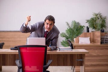 Young businessman employee in bullying concept in the office