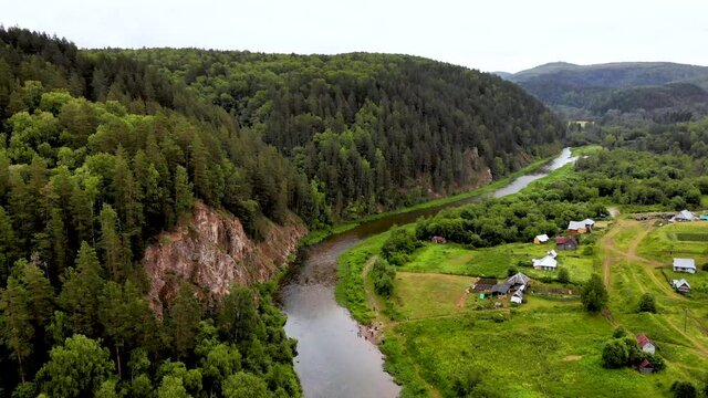 The Inzer River in the Republic of Bashkortostan. A river among rocks and trees.