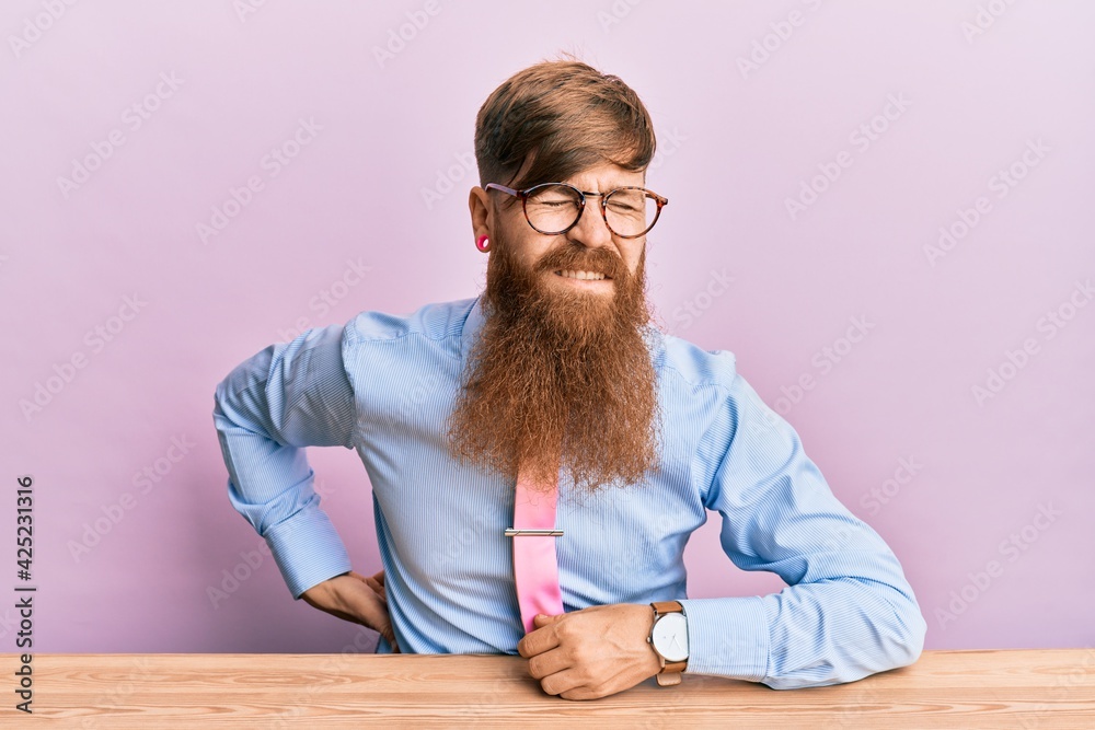 Canvas Prints young irish redhead man wearing business shirt and tie sitting on the table suffering of backache, t