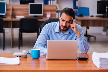 Young male employee working in the office