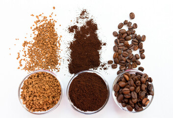 Coffee beans ground and instant in glass bowls on a white background. View from above