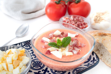 
Salmorejo, cold tomato soup typical of Spanish cuisine in summer. Tomato soup with boiled egg and Serrano ham, typical of Andalusian cuisine. Food photography