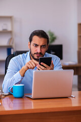 Young male employee working in the office