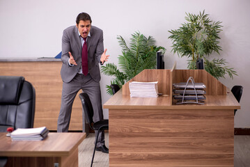 Young businessman employee in bullying concept in the office