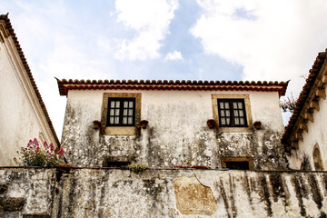 Fototapeta na wymiar Narrow and colorful streets, facades and balconies of Obidos