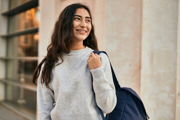 Young middle east student girl smiling happy standing at the city.