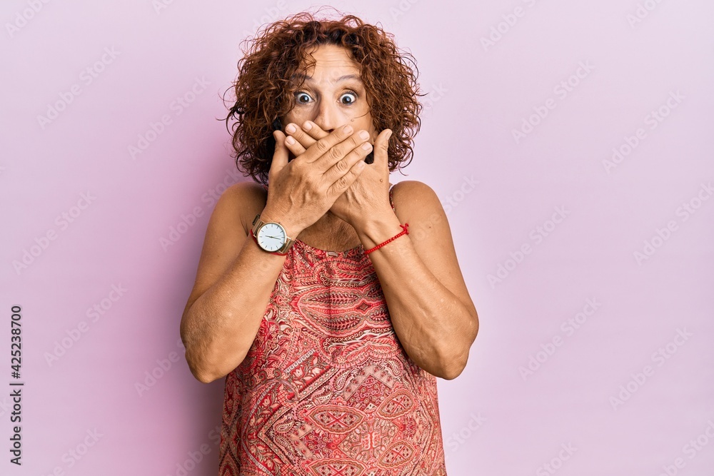 Poster beautiful middle age mature woman wearing summer dress shocked covering mouth with hands for mistake