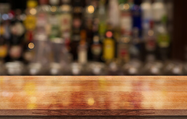 Empty wooden table top with lights bokeh on blur restaurant background.