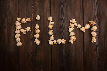popcorn laid out word movie on wooden background snack