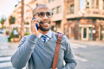 Young african american businessman smiling happy talking on the smartphone at the city.